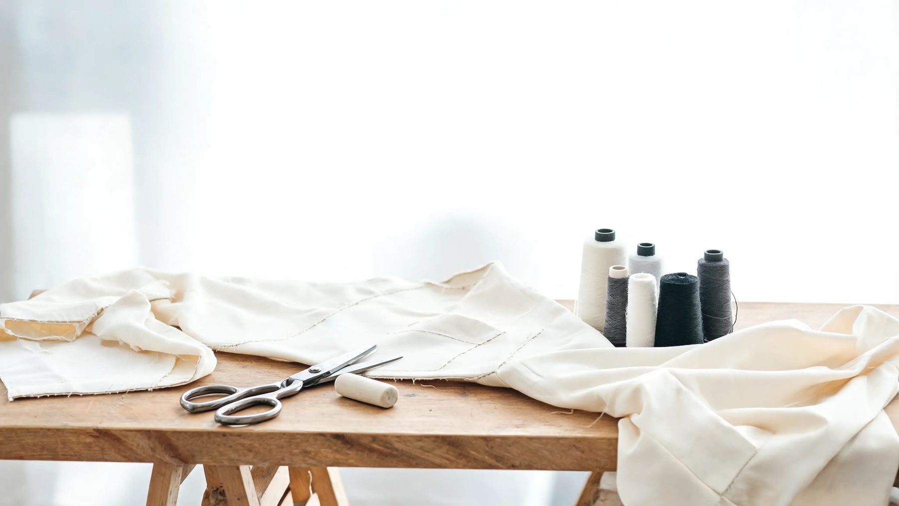 Workroom bench with shears, chalk and thread
